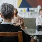 Man in Black Suit Jacket Using Smartphone