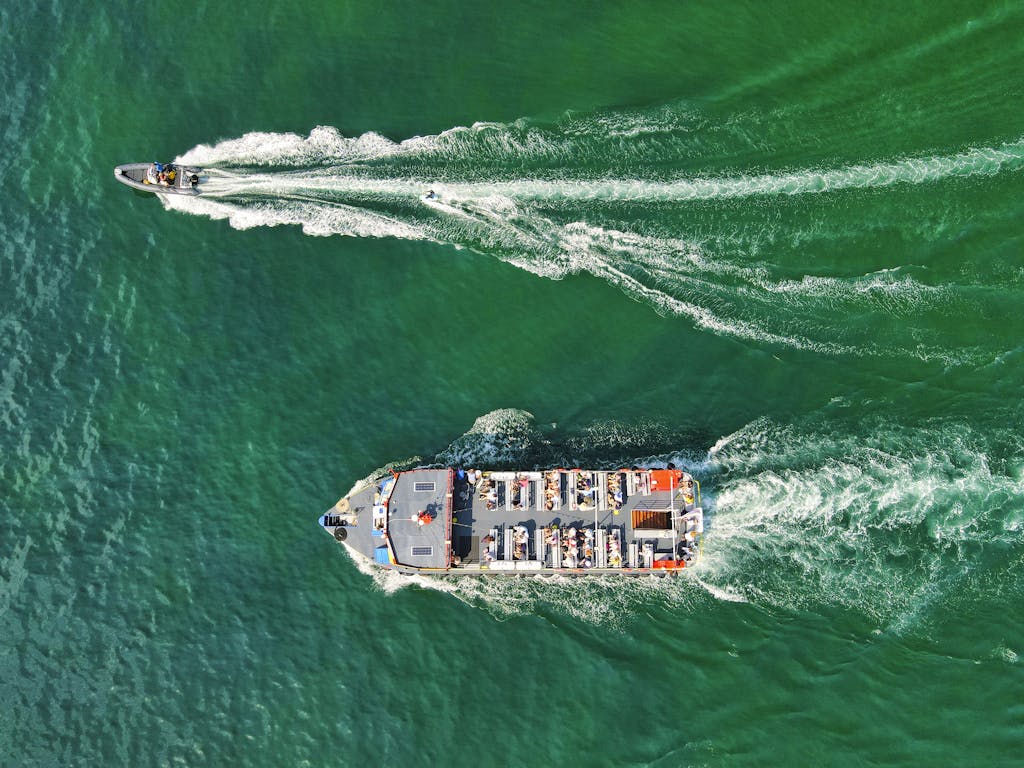Speedboat and Ferryboat Sailing on the Water